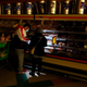 Customers use the light from a cellphone to look in the meat section of a grocery store on Feb. 16, 2021 in Dallas, Texas. Even though the store lost power, it was open for cash only sales.